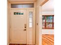 A white entry door is highlighted with adjacent glass panes, which allow natural light in at 9614 W Powers Cir, Littleton, CO 80123