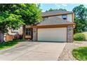 Lovely two-story home featuring a two-car garage and rock landscaping accents at 9614 W Powers Cir, Littleton, CO 80123
