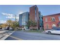 Modern brick apartment building with street view and parked cars at 2460 W 29Th Ave # 303, Denver, CO 80211