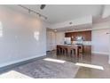 Bright living space leading to the kitchen area, featuring sleek floors and minimalist design elements at 2460 W 29Th Ave # 303, Denver, CO 80211