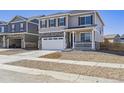 Charming two-story home with a two-car garage, front porch, and neutral siding at 245 S Vandriver Way, Aurora, CO 80018