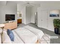 Tranquil staged bedroom with vaulted ceilings, ceiling fan, ensuite bathroom and soft lighting, ready to unwind at 124 High Country Trl, Lafayette, CO 80026