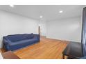 Inviting living room with hardwood floors, recessed lights, and a view to another room at 690 W 1St Ave, Broomfield, CO 80020