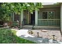 Inviting front porch with beautiful landscaping, garden lighting, and a walkway to the front door at 2130 Chestnut Cir, Erie, CO 80516