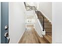 Bright entryway with modern staircase and wood-look floors at 8588 Eagle River St, Littleton, CO 80125