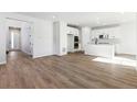 Open concept kitchen with white cabinets and island at 8588 Eagle River St, Littleton, CO 80125