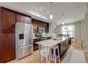 Bright kitchen with an island, stainless steel appliances, and stylish pendant lighting at 2426 Welton St, Denver, CO 80205