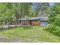 Cozy single-story home featuring a well-maintained lawn and a welcoming front porch area at 2220 Lee St, Lakewood, CO 80215