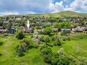 An areal view of the home showing the surrounding neighborhood and greenery at 14023 W Alaska Dr, Lakewood, CO 80228