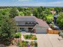 An overhead view of the home highlighting its solar panels, lush greenery, and well-maintained landscaping at 14023 W Alaska Dr, Lakewood, CO 80228