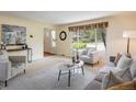 Cozy living room featuring neutral tones, large windows, and comfortable seating, perfect for relaxation at 14023 W Alaska Dr, Lakewood, CO 80228