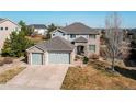 Stunning aerial view of a home featuring a spacious driveway and manicured lawn at 16590 Hitching Post Cir, Parker, CO 80134