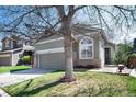 Inviting home exterior showcasing the lawn and attached two-car garage at 1374 Spotted Owl Way, Highlands Ranch, CO 80129
