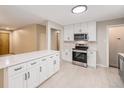 Stylish kitchen with white cabinets, stainless steel appliances, and an island at 260 Flint Way, Broomfield, CO 80020