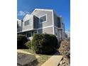 View of townhouse with gray siding, white trim, and a walkway leading to the entrance at 6585 W 84Th Way # 109, Arvada, CO 80003