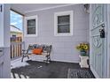 Cozy front porch with a bench and potted sunflowers, creating a welcoming entrance at 3311 S Logan St, Englewood, CO 80113