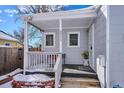 Inviting front porch with white railings and a bench, perfect for relaxing at 3311 S Logan St, Englewood, CO 80113