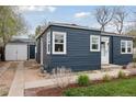 View of the home's side and backyard, showcasing the clean lines and a detached garage at 3740 W 54Th Ave, Denver, CO 80221