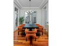 Elegant dining room features modern chandelier, large window, and seating for six at 8044 E 24Th Ave, Denver, CO 80238