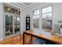 Bright office space with hardwood floors, large windows, and glass doors to outdoor area at 8044 E 24Th Ave, Denver, CO 80238