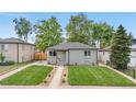 Charming home with a well-manicured lawn and a cozy patio area at 3541 Eudora St, Denver, CO 80207