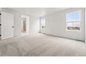 Spacious bedroom with carpet, two windows, and an en suite bathroom at 7267 Prairie Sage Pl, Littleton, CO 80125