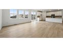 Bright living room featuring hardwood floors and sliding door access to outdoor living at 7267 Prairie Sage Pl, Littleton, CO 80125