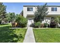 Two-story home with well-manicured lawn and pathway to front door at 6795 E Arizona Ave # B, Denver, CO 80224