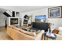 Spacious living room features a fireplace and leather sectional at 6795 E Arizona Ave # B, Denver, CO 80224