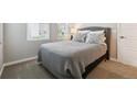 Calm bedroom featuring soft carpet, neutral walls and a comfortable bed with stylish pillows at 8883 Ramblestone St, Highlands Ranch, CO 80129