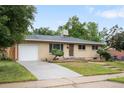 Ranch-style home with a brick exterior, driveway, and a well-kept front yard at 3054 S Raleigh St, Denver, CO 80236