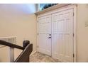 Entryway featuring double doors and a staircase with a dark brown handrail at 11462 W Tennessee Pl, Lakewood, CO 80226