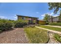 Exterior of a well-maintained two-story house with front yard featuring mature landscaping and an attached garage at 11462 W Tennessee Pl, Lakewood, CO 80226
