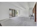 Spacious living room with neutral carpet, sliding glass doors and bar seating area at 2525 S Dayton Way # 1510, Denver, CO 80231