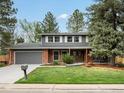 Charming two-story home featuring a well-manicured front yard at 5845 W Portland Dr, Littleton, CO 80128