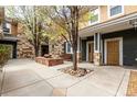 Inviting courtyard entrance featuring a fire pit, mature trees, and access to multiple units at 3577 Molly Cir, Broomfield, CO 80023