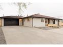 Spacious property with a long driveway leading to a two-car garage at 4395 Newland St, Wheat Ridge, CO 80033