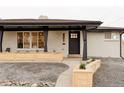 Charming home featuring a brick facade, a dark front door, and stylish planters at 4395 Newland St, Wheat Ridge, CO 80033