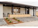 Landscaped front exterior with planter boxes, stepping stones, and charming curb appeal at 4395 Newland St, Wheat Ridge, CO 80033