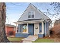 Inviting two-story home featuring a covered front porch with classic white columns at 2515 Zenobia St, Denver, CO 80212