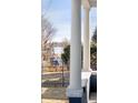 Covered front porch featuring classic white columns and serene lake view at 2515 Zenobia St, Denver, CO 80212