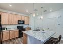 Bright kitchen featuring stainless steel appliances, granite countertops, and ample storage space at 17962 E 103Rd Ave, Commerce City, CO 80022