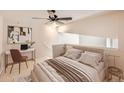 Cozy bedroom with neutral tones, a desk space, and a large window for natural light at 9481 E Mansfield Ave # 305, Aurora, CO 80014