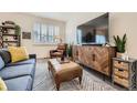 Comfortable living room with stylish furnishings, including a TV, sofa, and leather chair at 16135 Mountain Flax Dr, Monument, CO 80132