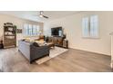Well-lit living room with hardwood floors, modern furniture, and large windows with shutters at 16135 Mountain Flax Dr, Monument, CO 80132