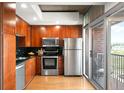 Kitchen features stainless steel appliances, modern cabinetry, and balcony access at 1700 Bassett St # 609, Denver, CO 80202