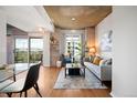 Bright living room features hardwood floors, modern furniture, and outdoor balcony access at 1700 Bassett St # 609, Denver, CO 80202
