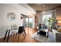 Living room features hardwood floors, modern furniture, and outdoor balcony access at 1700 Bassett St # 609, Denver, CO 80202
