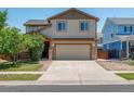 Charming two-story home with a two-car garage and well-maintained front yard during the day at 5572 Kalispell St, Denver, CO 80239