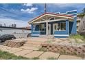 Charming blue duplex with a red tile roof and stone landscaping at 2838 Decatur St, Denver, CO 80211